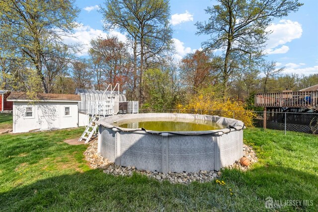 651 Myrtle Rd, North Brunswick, NJ 08902 - view of swimming pool featuring an outbuilding and a wooden deck
