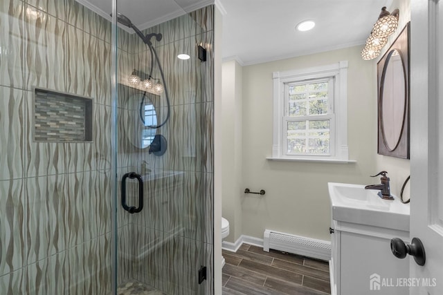651 Myrtle Rd, North Brunswick, NJ 08902 - bathroom featuring a baseboard heating unit, crown molding, vanity, baseboards, and a stall shower