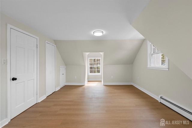 651 Myrtle Rd, North Brunswick, NJ 08902 - additional living space featuring a baseboard heating unit, light wood-style floors, baseboards, and lofted ceiling