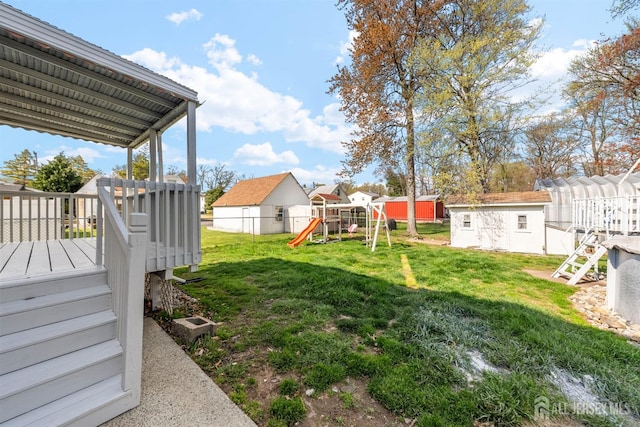 651 Myrtle Rd, North Brunswick, NJ 08902 - view of yard with a playground, a storage shed, an outbuilding, a deck, and stairway