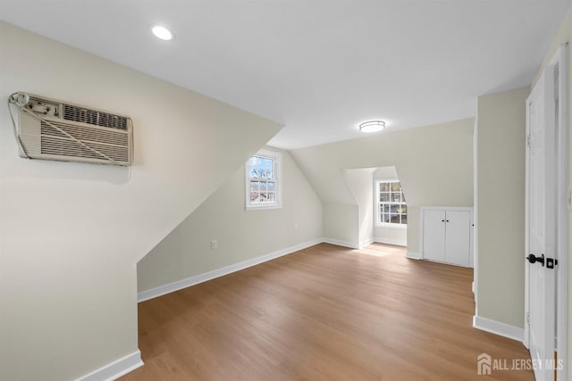 651 Myrtle Rd, North Brunswick, NJ 08902 - bonus room featuring a wall mounted AC, baseboards, light wood finished floors, vaulted ceiling, and recessed lighting