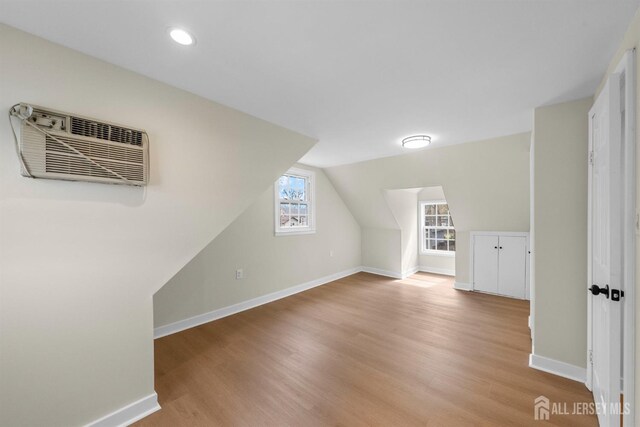 651 Myrtle Rd, North Brunswick, NJ 08902 - bonus room with light wood-style flooring, a wall unit AC, lofted ceiling, and recessed lighting