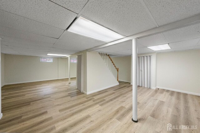 651 Myrtle Rd, North Brunswick, NJ 08902 - finished basement featuring a paneled ceiling, wood finished floors, and stairs