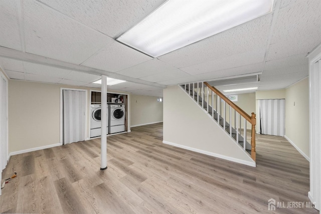 651 Myrtle Rd, North Brunswick, NJ 08902 - finished below grade area with independent washer and dryer, stairway, baseboards, wood finished floors, and a paneled ceiling