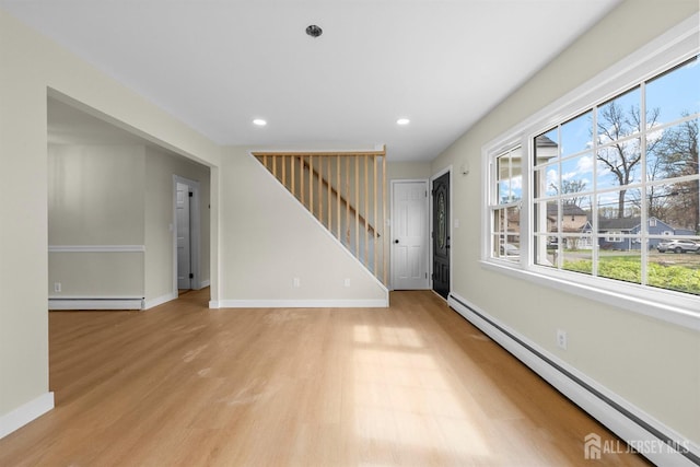 651 Myrtle Rd, North Brunswick, NJ 08902 - unfurnished living room with baseboard heating, stairs, light wood-style floors, recessed lighting, and baseboards