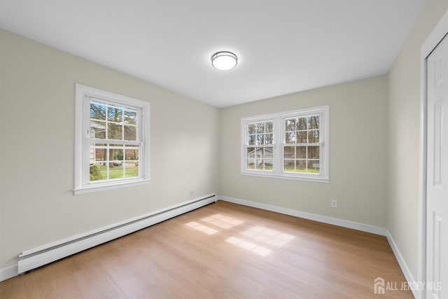 651 Myrtle Rd, North Brunswick, NJ 08902 - unfurnished bedroom with baseboard heating, wood finished floors, baseboards, and a closet