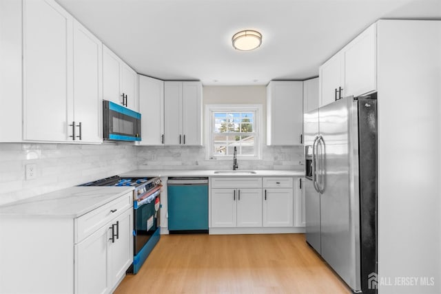 651 Myrtle Rd, North Brunswick, NJ 08902 - kitchen featuring stainless steel fridge with ice dispenser, dishwashing machine, black microwave, gas stove, and a sink