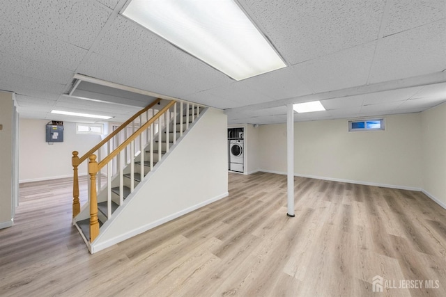 651 Myrtle Rd, North Brunswick, NJ 08902 - basement featuring washer / dryer, a drop ceiling, wood finished floors, baseboards, and stairway