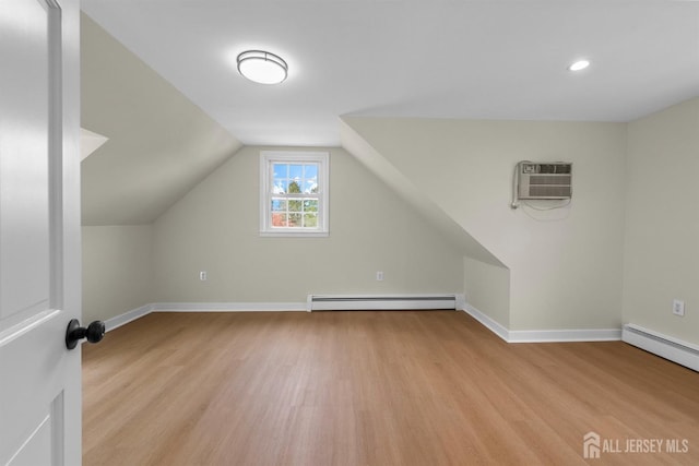 651 Myrtle Rd, North Brunswick, NJ 08902 - additional living space featuring baseboard heating, a wall mounted air conditioner, light wood-style flooring, baseboards, and recessed lighting