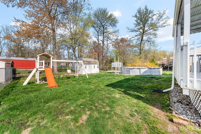 651 Myrtle Rd, North Brunswick, NJ 08902 - view of yard with a shed, a playground, and an outbuilding