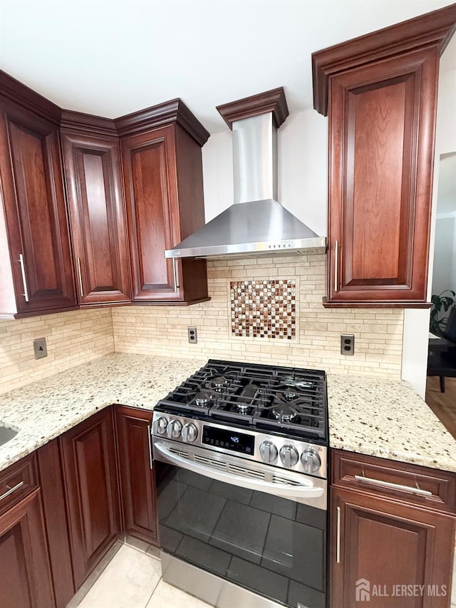 23 Prospect St, Old Bridge, NJ 08857 - kitchen with wall chimney exhaust hood, stainless steel range with gas cooktop, light stone countertops, and tasteful backsplash