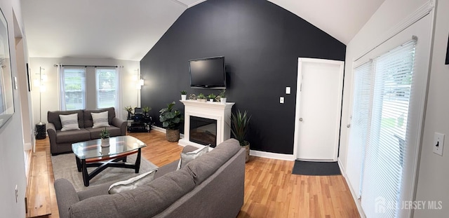 23 Prospect St, Old Bridge, NJ 08857 - living room featuring lofted ceiling, light wood-type flooring, and a glass covered fireplace