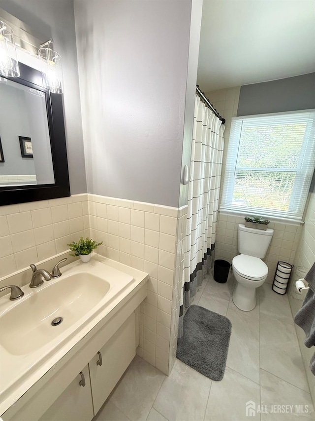 23 Prospect St, Old Bridge, NJ 08857 - bathroom with tile walls, vanity, tile patterned flooring, a wainscoted wall, and curtained shower