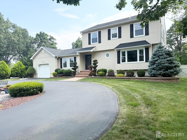 23 Prospect St, Old Bridge, NJ 08857 - view of front of property with curved driveway, a front lawn, an attached garage, and roof with shingles
