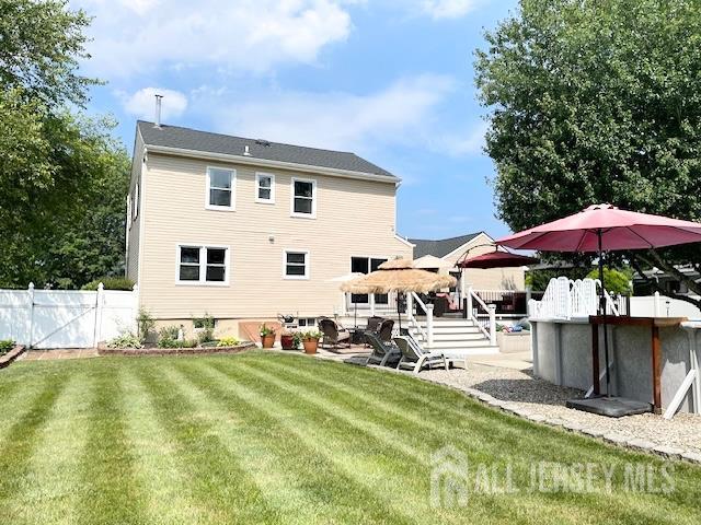 23 Prospect St, Old Bridge, NJ 08857 - back of property with a deck and a patio