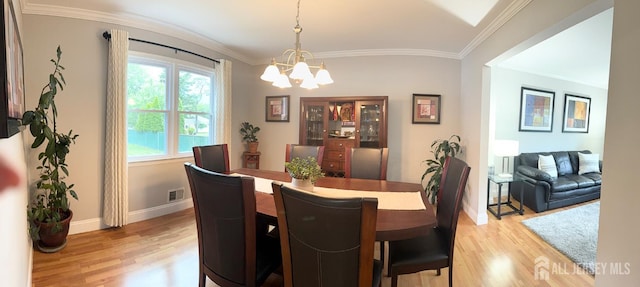 23 Prospect St, Old Bridge, NJ 08857 - dining room with light wood-style floors, a chandelier, and ornamental molding