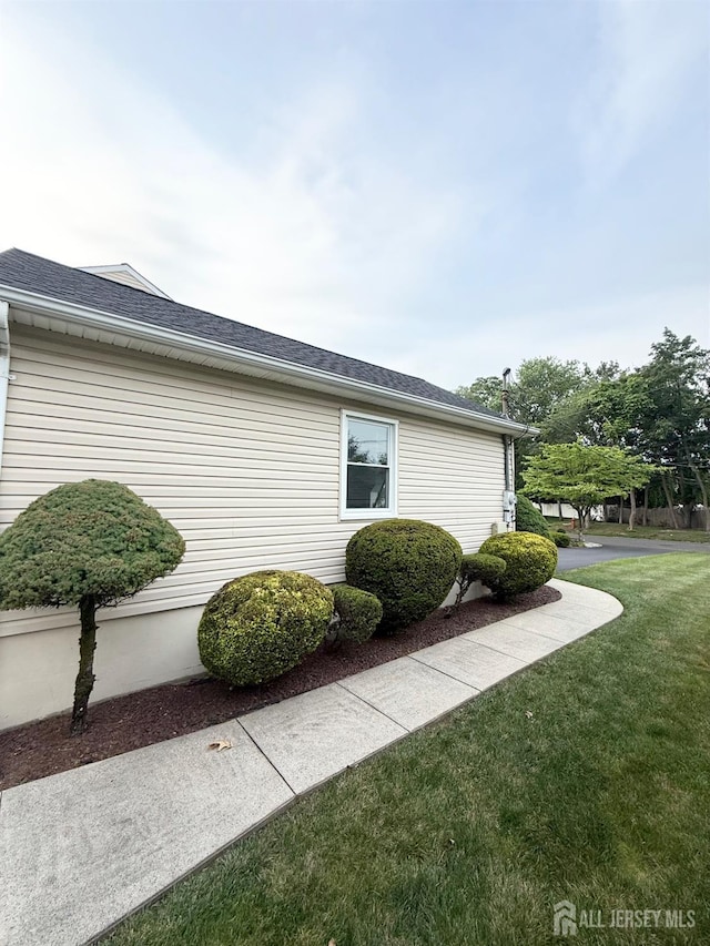 23 Prospect St, Old Bridge, NJ 08857 - view of side of property with a yard and roof with shingles