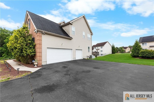 6 Monet Ct, South Brunswick, NJ 08852 - view of side of home with an attached garage, roof with shingles, driveway, a yard, and brick siding