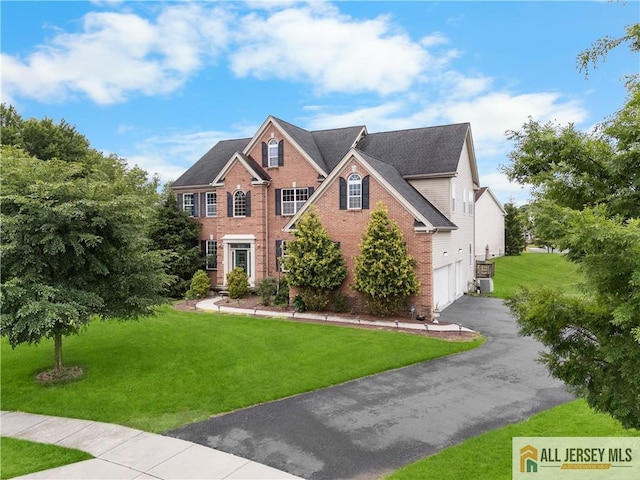 6 Monet Ct, South Brunswick, NJ 08852 - view of front of home featuring brick siding, driveway, a front yard, and a garage