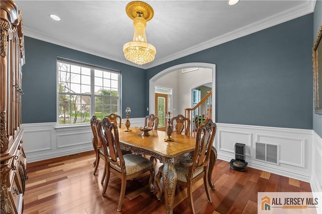 6 Monet Ct, South Brunswick, NJ 08852 - dining room featuring arched walkways, a wainscoted wall, wood finished floors, ornamental molding, and recessed lighting