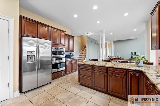 6 Monet Ct, South Brunswick, NJ 08852 - kitchen featuring appliances with stainless steel finishes, light stone counters, ornate columns, light tile patterned floors, and recessed lighting