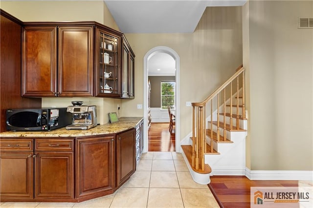 6 Monet Ct, South Brunswick, NJ 08852 - bar with arched walkways, stairs, and light tile patterned floors