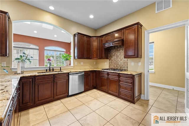 6 Monet Ct, South Brunswick, NJ 08852 - kitchen with stainless steel appliances, decorative backsplash, light tile patterned flooring, recessed lighting, and arched walkways