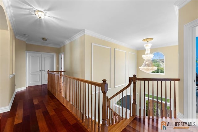 6 Monet Ct, South Brunswick, NJ 08852 - corridor featuring wood finished floors, an upstairs landing, ornamental molding, and a chandelier