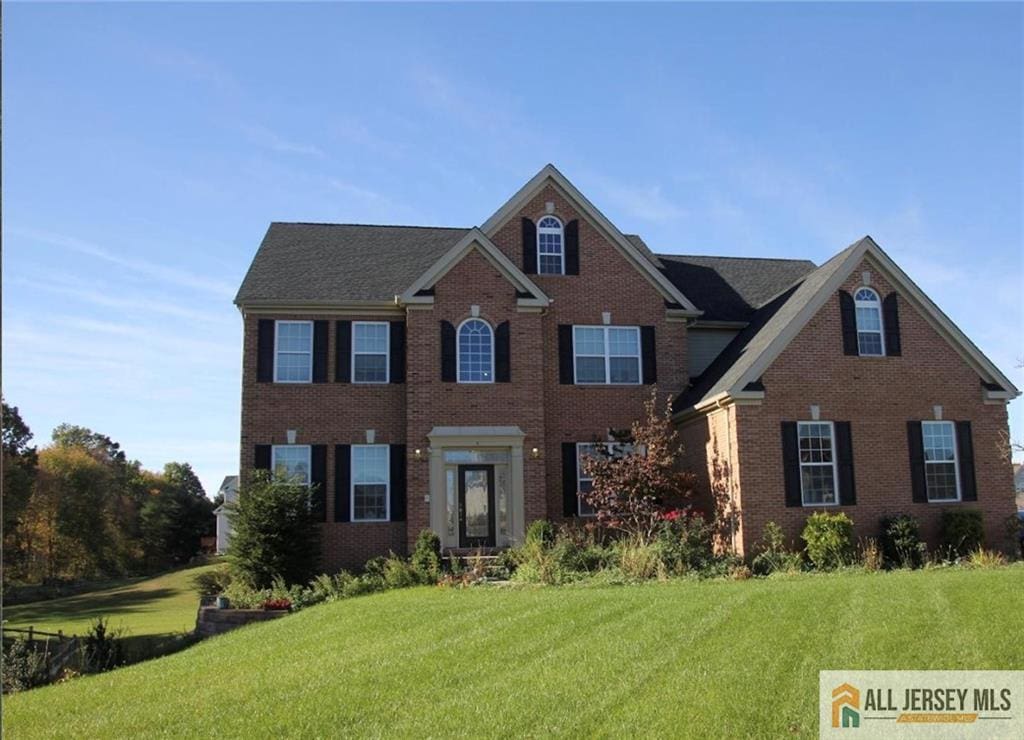6 Monet Ct, South Brunswick, NJ 08852 - colonial home featuring a front yard and brick siding