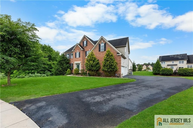 6 Monet Ct, South Brunswick, NJ 08852 - view of front of home featuring an attached garage, asphalt driveway, brick siding, and a front yard