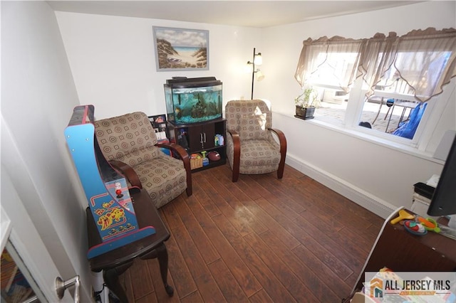 sitting room with hardwood / wood-style floors and baseboards