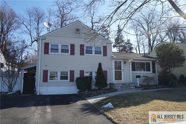 split level home featuring aphalt driveway and a front yard