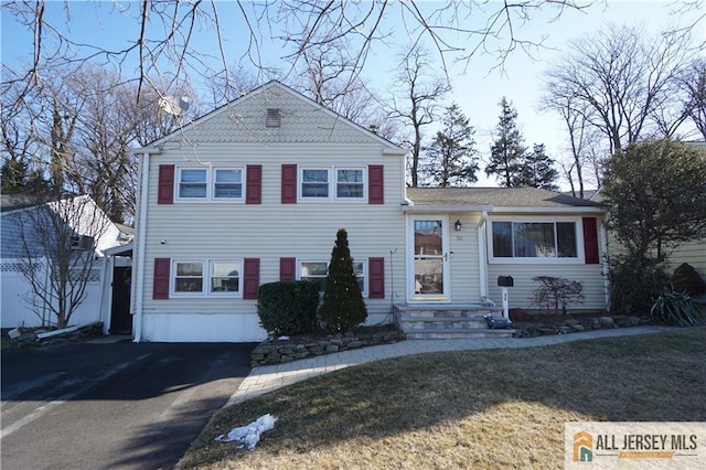 split level home with driveway and entry steps