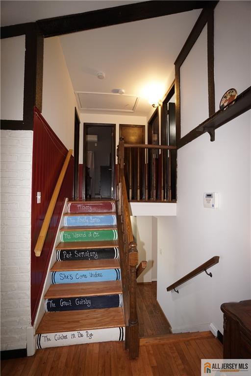 stairway featuring wood-type flooring