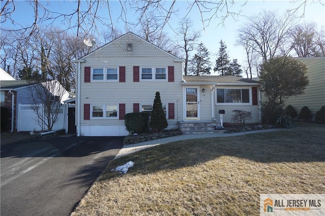 split level home featuring driveway and a front yard