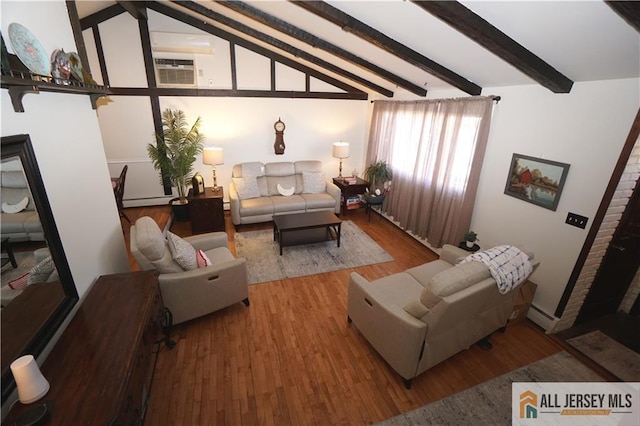 living area featuring lofted ceiling with beams, a fireplace, wood finished floors, baseboard heating, and a wall mounted AC