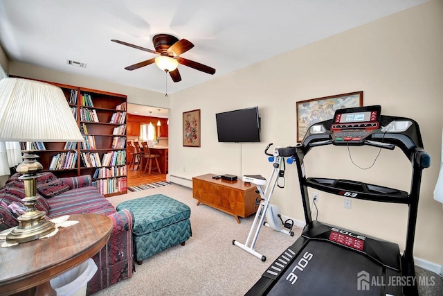 exercise room with carpet, ceiling fan, baseboard heating, and visible vents