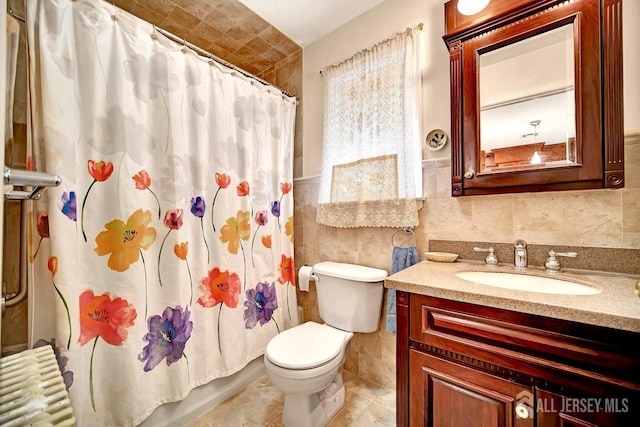 full bathroom featuring vanity, wainscoting, toilet, tile walls, and radiator heating unit