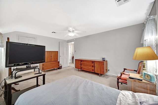 bedroom featuring a ceiling fan, visible vents, and light carpet