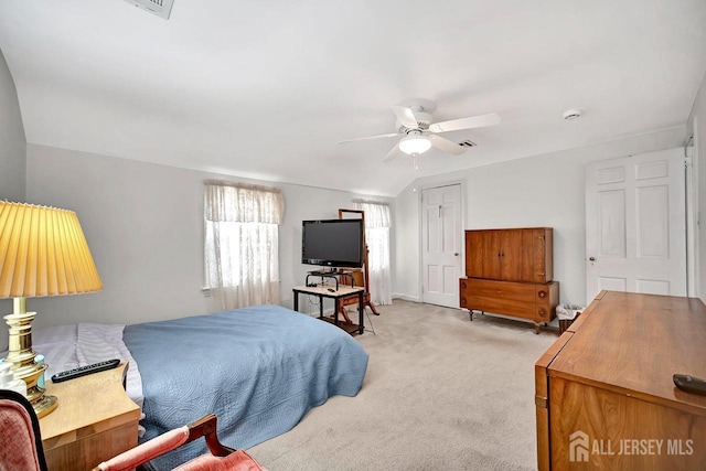 bedroom featuring a ceiling fan and light colored carpet