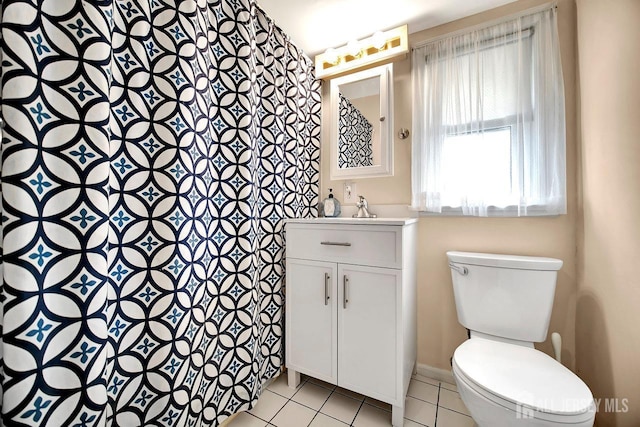 bathroom featuring vanity, toilet, tile patterned floors, baseboards, and a shower with curtain