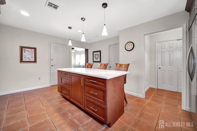 kitchen with visible vents, light tile patterned floors, baseboards, light countertops, and recessed lighting