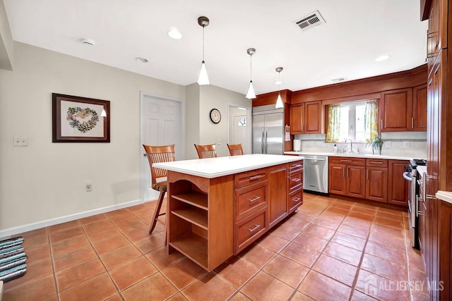 kitchen with appliances with stainless steel finishes, a center island, open shelves, a sink, and light countertops
