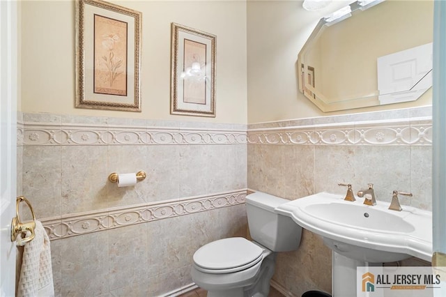 34 Schindler Ct Unit 17, Lawrence, NJ 08648 - bathroom with tile walls, wainscoting, and toilet