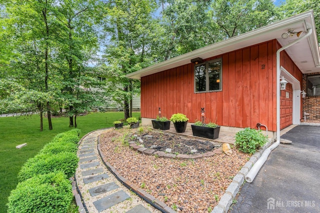 2 Crommelin Ct, East Brunswick, NJ 08816 - view of side of home featuring a lawn, board and batten siding, and a garage