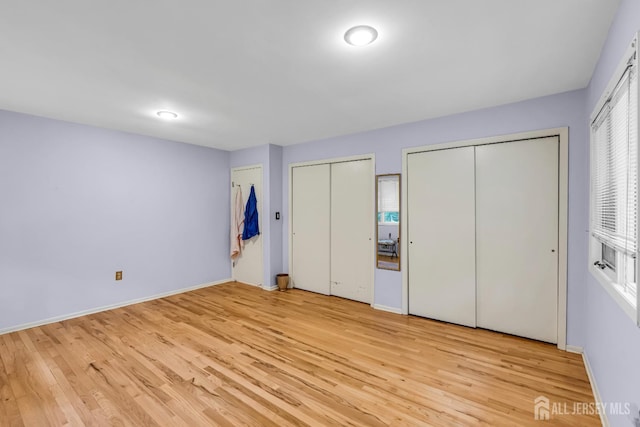 2 Crommelin Ct, East Brunswick, NJ 08816 - unfurnished bedroom featuring multiple closets and wood finished floors