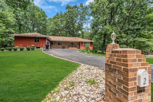 2 Crommelin Ct, East Brunswick, NJ 08816 - ranch-style house with driveway, a front lawn, a garage, a shingled roof, and view of wooded area