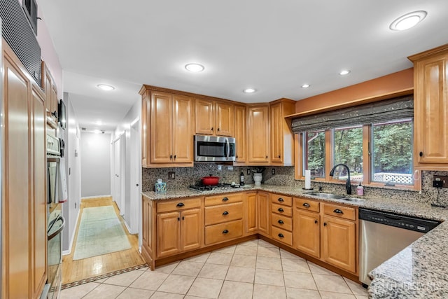 2 Crommelin Ct, East Brunswick, NJ 08816 - kitchen with appliances with stainless steel finishes, light tile patterned flooring, backsplash, light stone countertops, and recessed lighting
