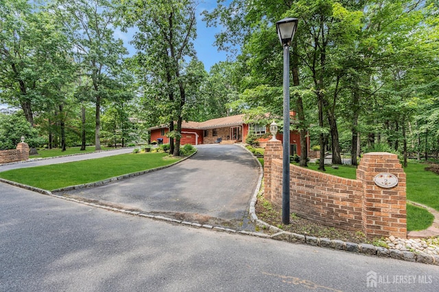2 Crommelin Ct, East Brunswick, NJ 08816 - view of front of home with asphalt driveway, a front yard, and an attached garage
