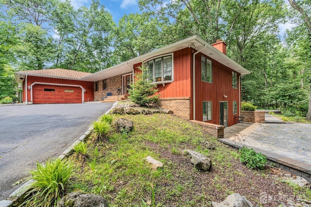 2 Crommelin Ct, East Brunswick, NJ 08816 - view of front facade featuring a chimney, asphalt driveway, and an attached garage